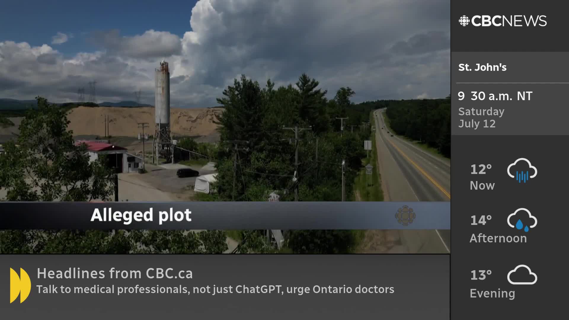 A tall, cylindrical structure stands near a building with a red roof, all set against a backdrop of a highway winding through the green landscape. The CBC News Network broadcast shows the scene, with the weather forecast for St. John's displayed on the right.
