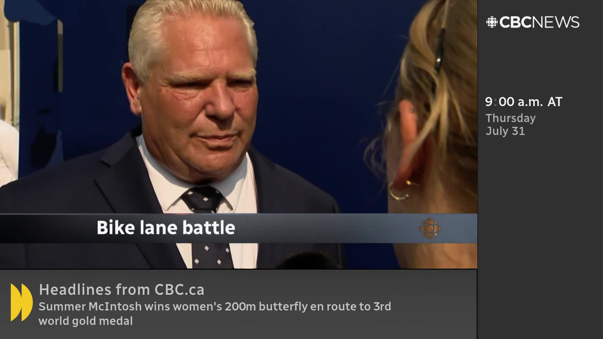 A man in a suit, identified as part of a "Bike lane battle" segment, is being interviewed by someone off-screen. The CBC News Network logo is visible in the corner, along with the date and time.

