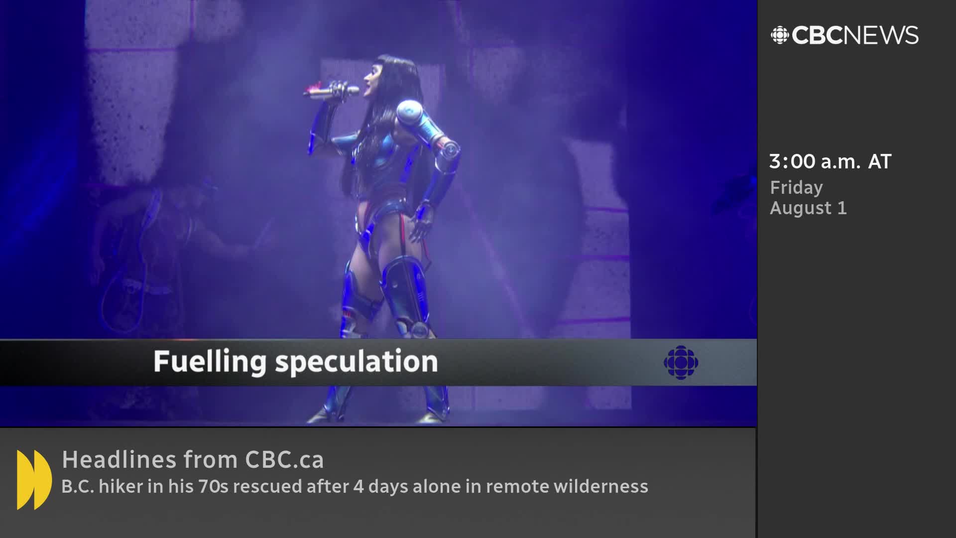 A performer in a futuristic costume stands center stage, holding a microphone. The CBC News Network graphic at the bottom suggests this is part of a segment "fuelling speculation."
