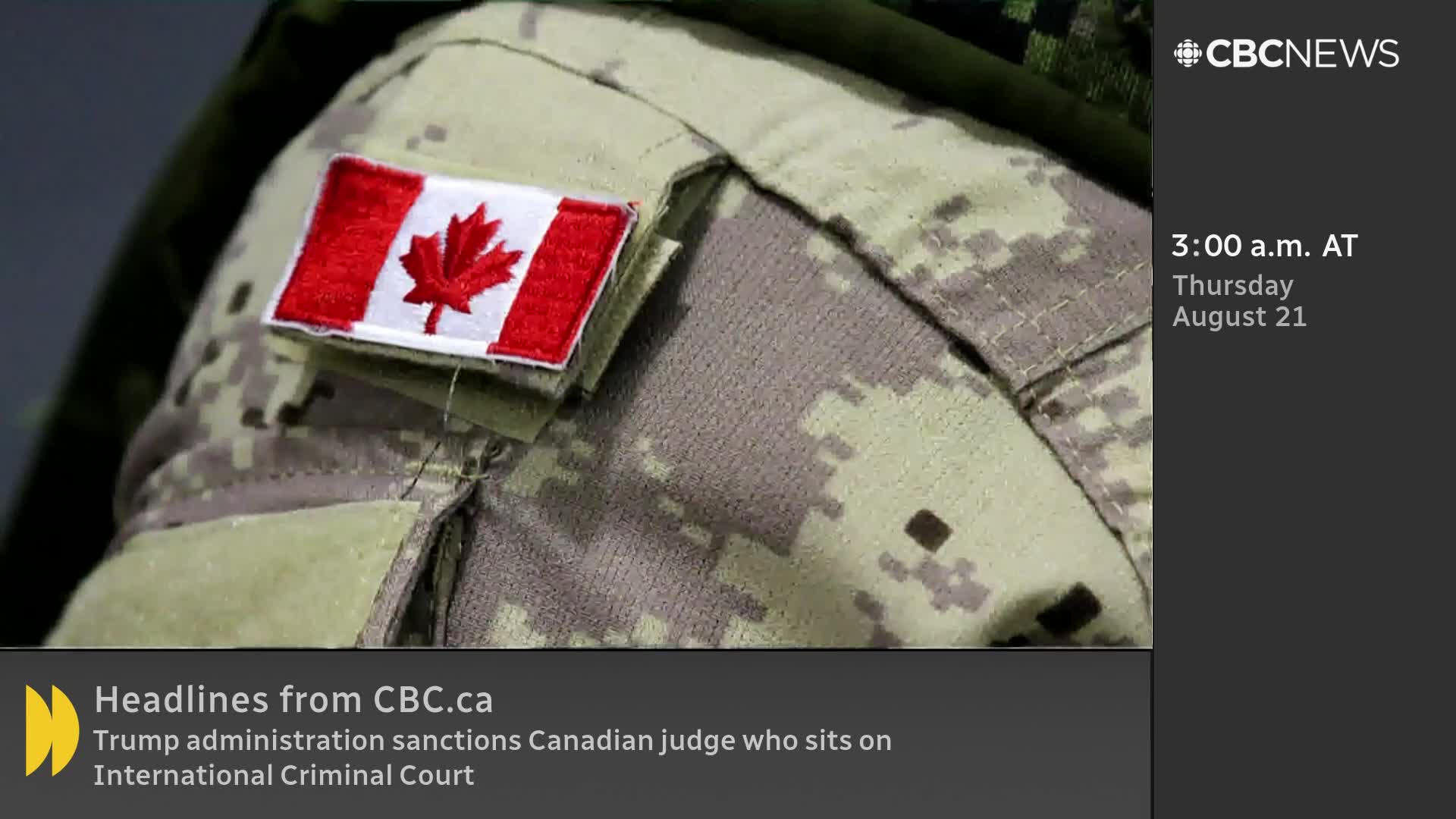 A Canadian flag patch sits on the shoulder of a soldier's camouflage uniform, as seen on CBC News Network. The time is 3:00 a.m. AT, Thursday, August 21, according to the screen.
