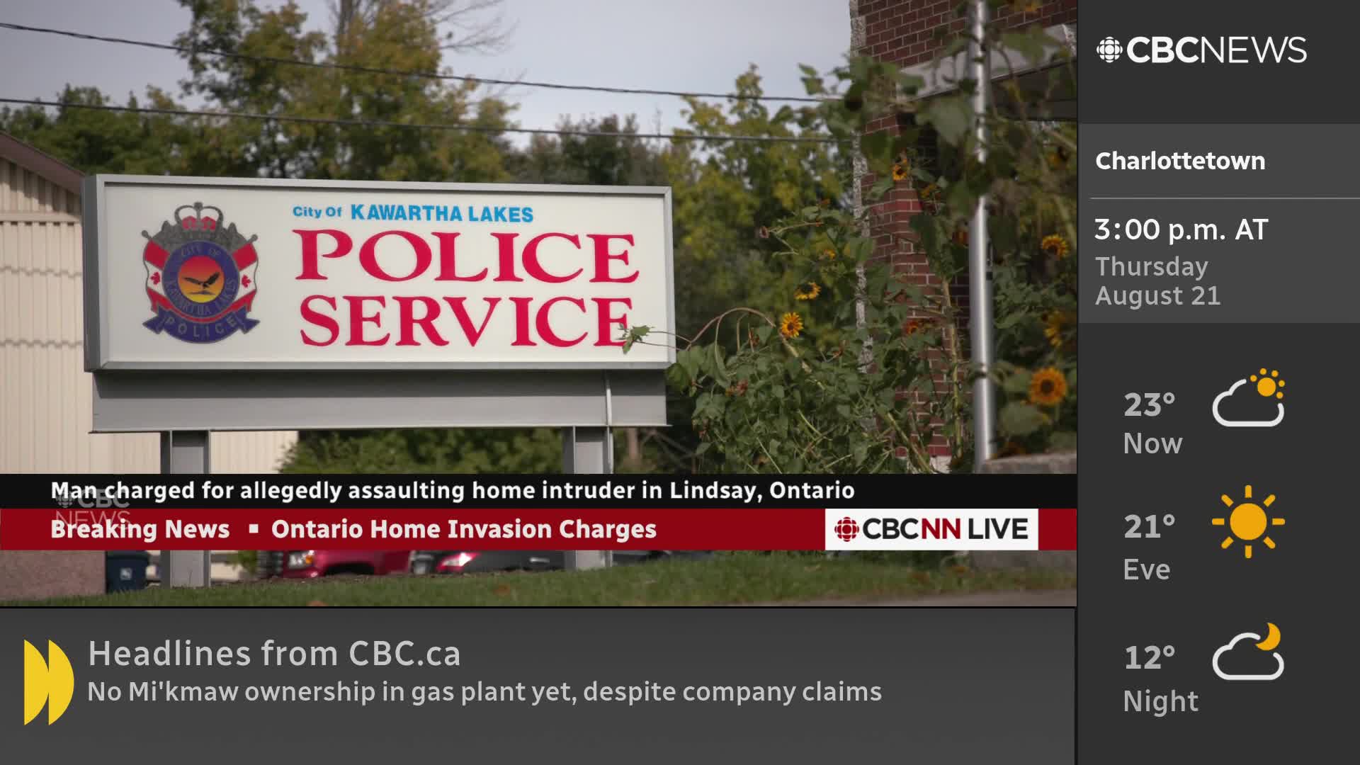 The CBC News Network logo and a weather report for Charlottetown sit beside a sign for the Kawartha Lakes Police Service. A red and white banner at the bottom of the screen announces breaking news about an Ontario home invasion.
