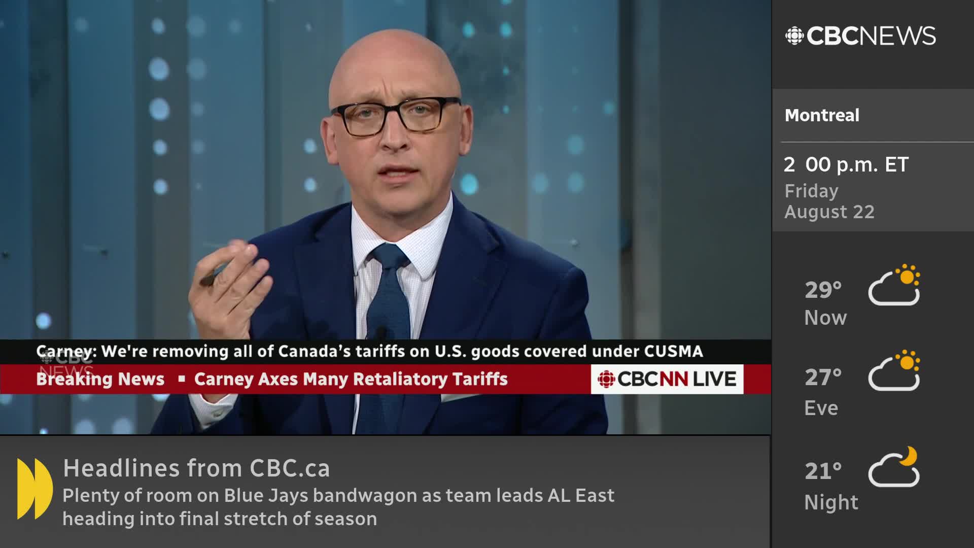 A man in a suit and glasses gestures with his hand while speaking on CBC News Network. The lower third displays breaking news about tariffs and the weather forecast for Montreal.
