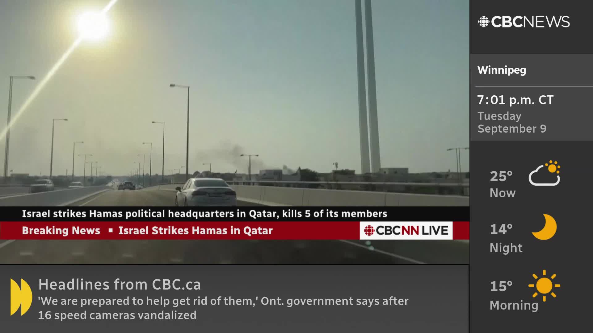 On a CBC News Network broadcast, a car drives down a highway under a bright sun, with a news banner displaying the headline about Israel striking Hamas in Qatar. The time in Winnipeg is 7:01 p.m.
