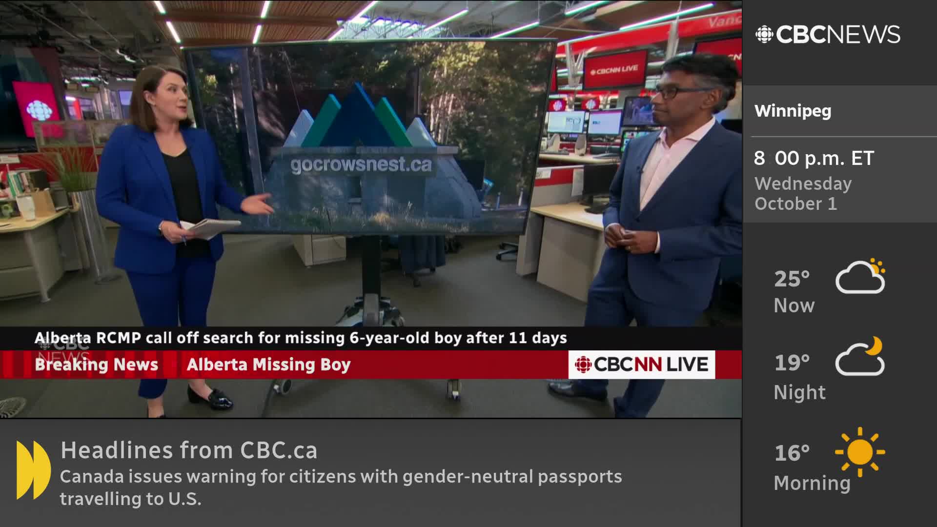 A woman in a blue suit gestures towards a screen displaying an image, while a man in a blazer stands nearby. The CBC News Network broadcast is reporting on the Alberta RCMP calling off a search for a missing boy.
