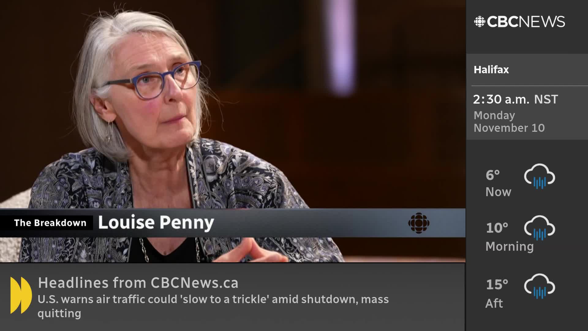 Louise Penny, wearing glasses, is speaking on a CBC News Network segment called "The Breakdown." The lower third of the screen shows headlines from CBCNews.ca, and the time and weather for Halifax are displayed on the right.
