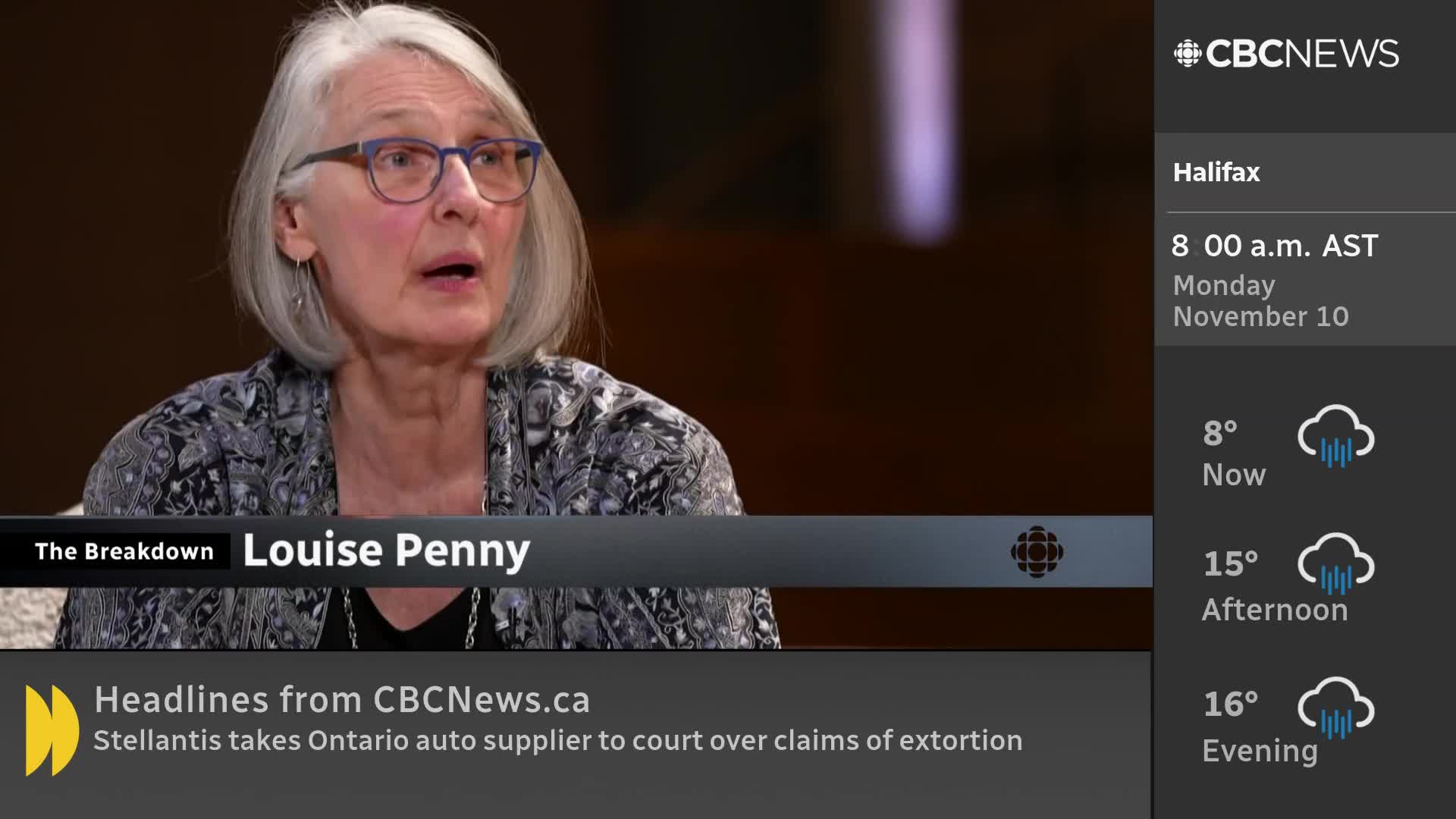 Louise Penny is speaking, her mouth open, as she's interviewed on CBC News Network. The Halifax weather forecast for the day is displayed to the right.
