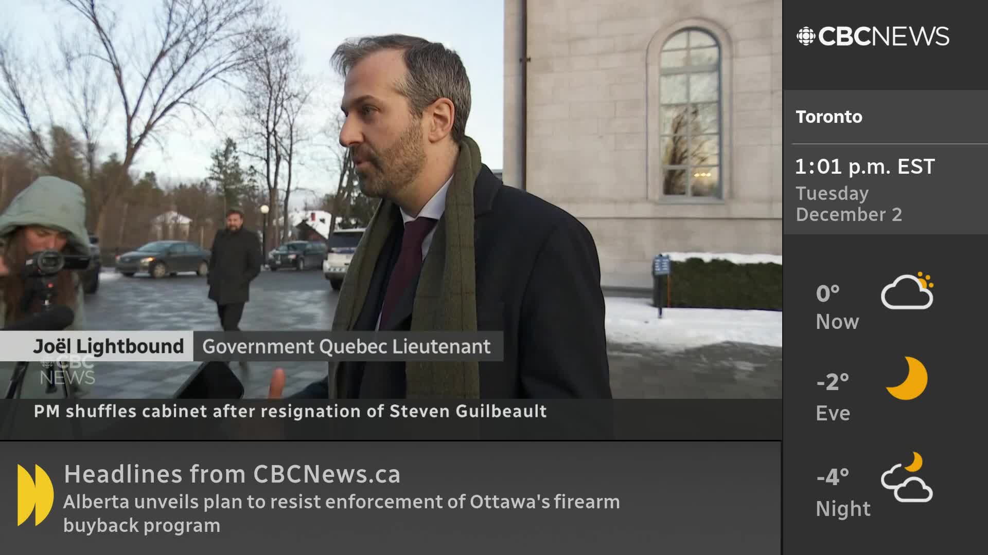 A man in a dark coat and scarf speaks to someone off-camera, likely a reporter, as a CBC News Network graphic identifies him as Joël Lightbound. Behind him, a few people walk in the distance, and the weather report in Toronto shows it's a chilly December day.
A man in a dark coat and scarf speaks to someone off-camera, likely a reporter, as a CBC News Network graphic identifies him as Joël Lightbound. Behind him, a few people walk in the distance, and the weather report in Toronto shows it's a chilly December day.