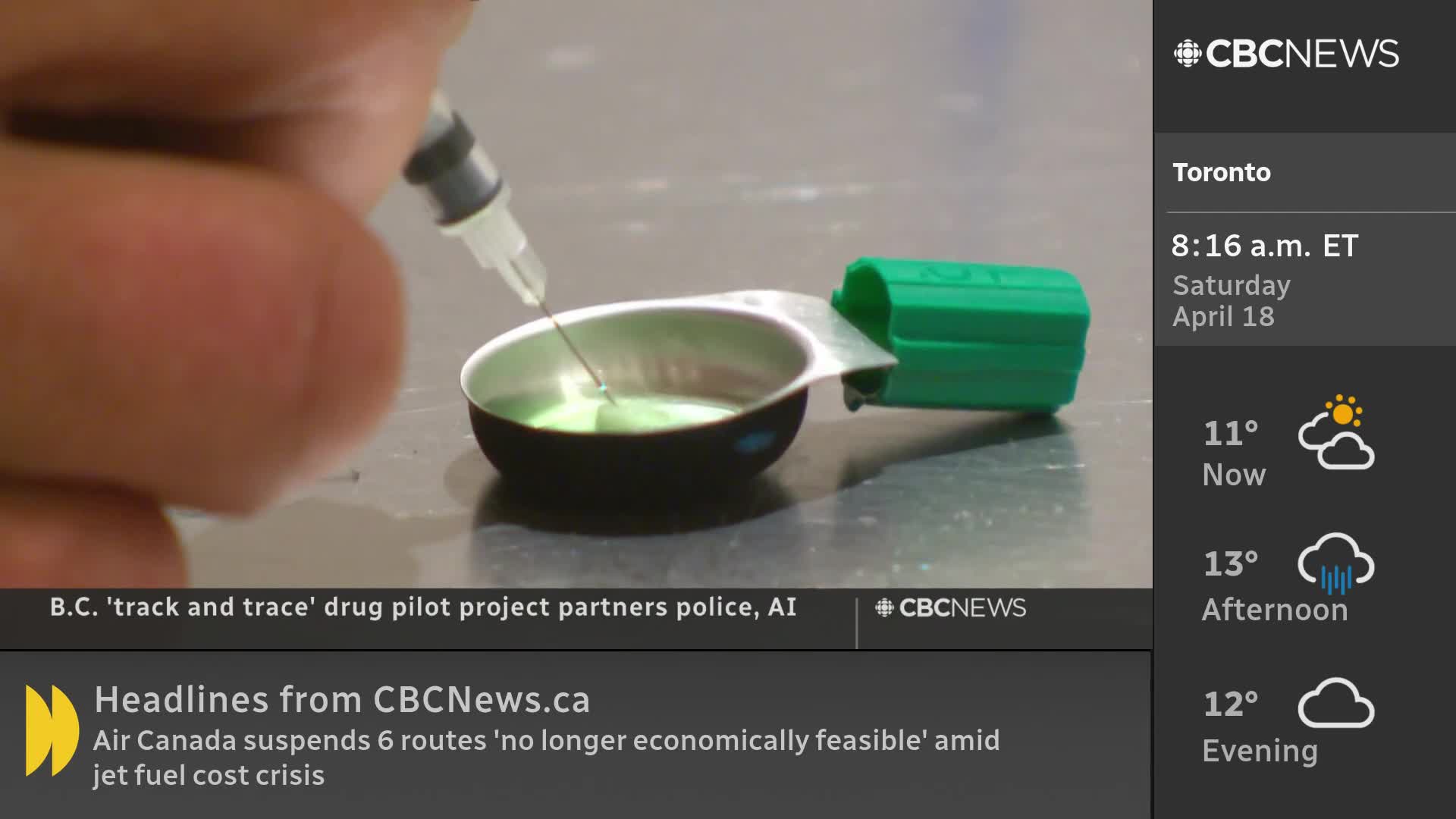 A needle dips into a small metal dish filled with a bright green liquid. A green cap sits beside the dish, and a portion of a finger holds the syringe steady.