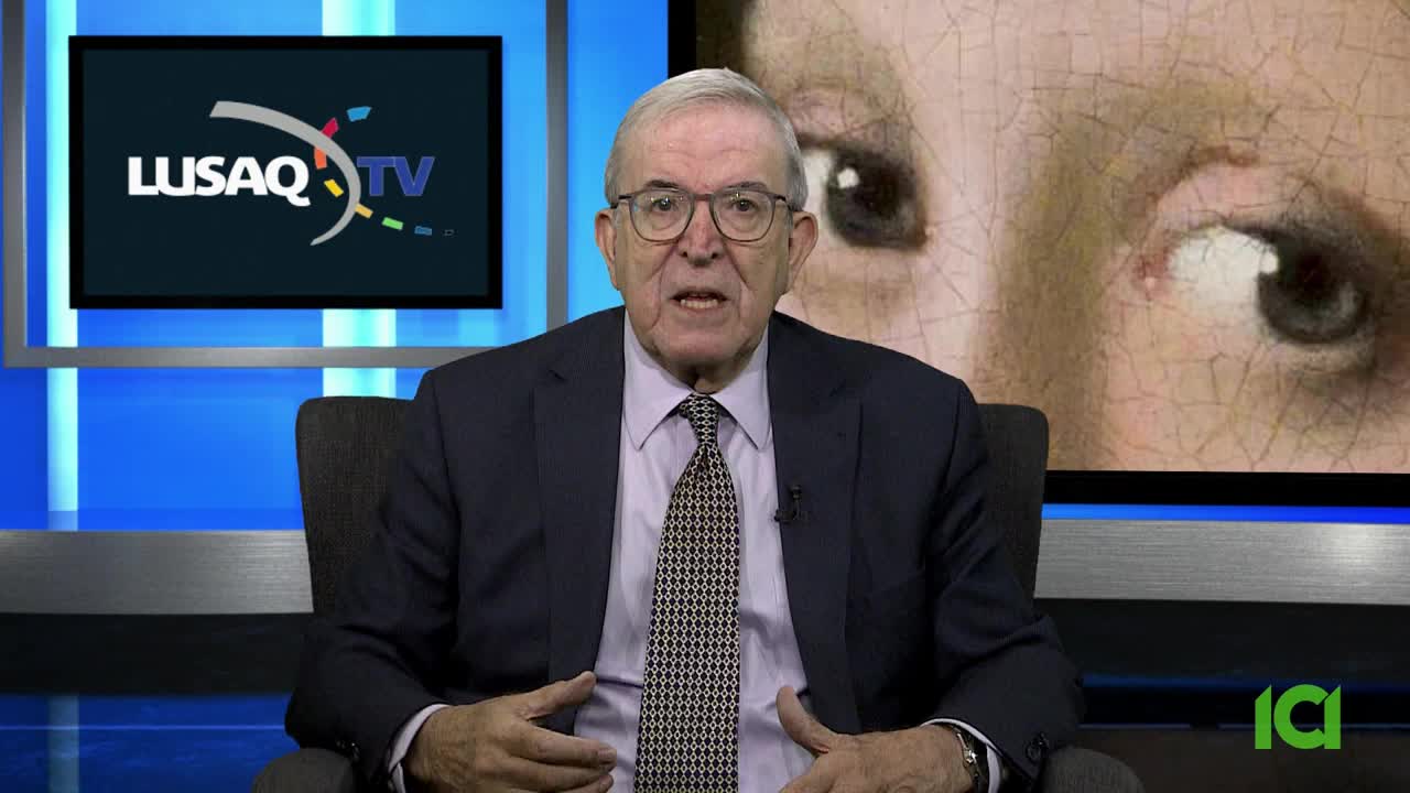 The man in the suit is speaking directly to the camera, framed by a backdrop of a painting and a screen displaying a logo. A CFHD-DT logo is visible in the corner.
