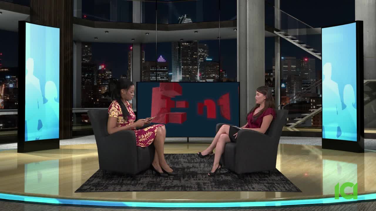 Two women sit facing each other in armchairs, the backdrop a cityscape at night. The CFHD-DT logo is visible in the corner as they converse.
