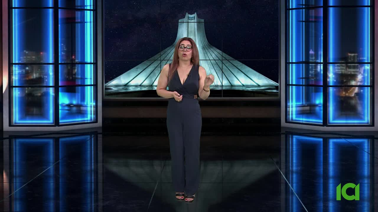 A woman in a dark jumpsuit gestures with her hands in front of a backdrop featuring a large monument. The set is framed by windows with glowing blue accents, and the logo for ICI is visible in the corner.
