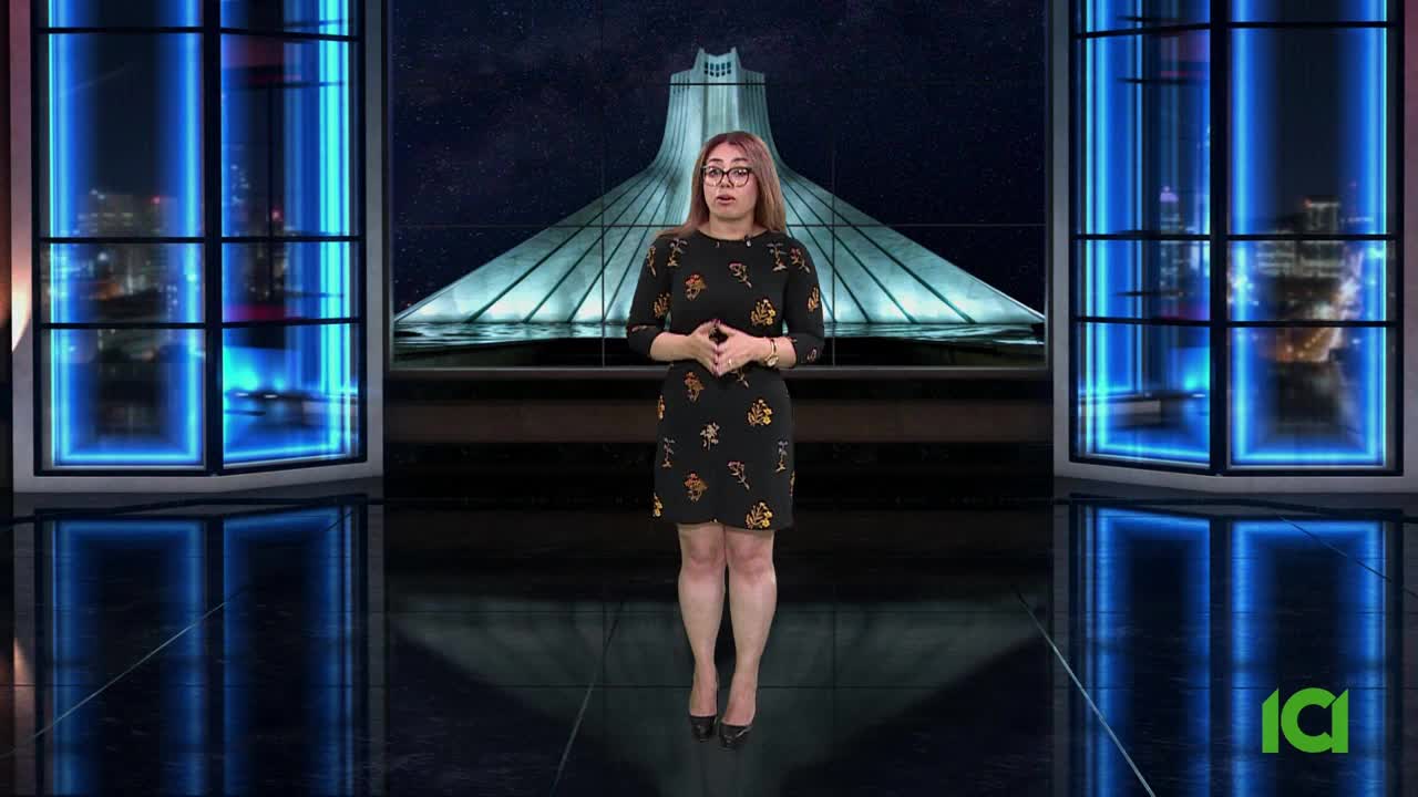 A woman in a black dress stands center stage, speaking in front of a backdrop featuring a large structure. The set, with its blue-lit window frames, is likely part of a CFHD-DT broadcast from Canada.
