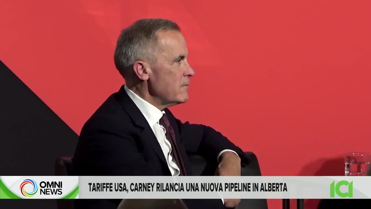 A man in a dark suit sits in profile, facing right, against a red backdrop. The CFHD-DT logo and a headline about tariffs and pipelines are at the bottom of the screen.
