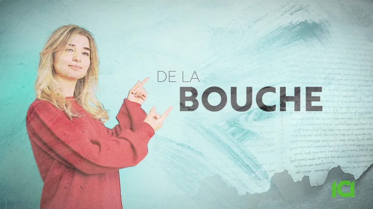 A woman in a red sweater gestures with both hands, pointing towards the words "DE LA BOUCHE." The background is a textured teal with some faint script.
A woman in a red sweater gestures with both hands, pointing towards the words "DE LA BOUCHE." The background is a textured teal with some faint script.