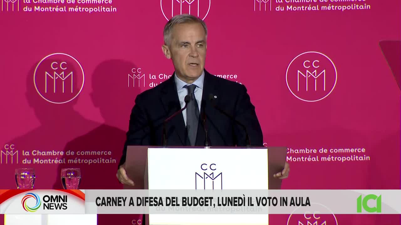 A man in a suit stands at a podium, speaking in front of a pink backdrop with the logo of the Montreal Metropolitan Chamber of Commerce. The CFHD-DT news ticker below reads "Carney a difesa del budget, lunedì il voto in aula."
A man in a suit stands at a podium, speaking in front of a pink backdrop with the logo of the Montreal Metropolitan Chamber of Commerce. The CFHD-DT news ticker below reads "Carney a difesa del budget, lunedì il voto in aula."