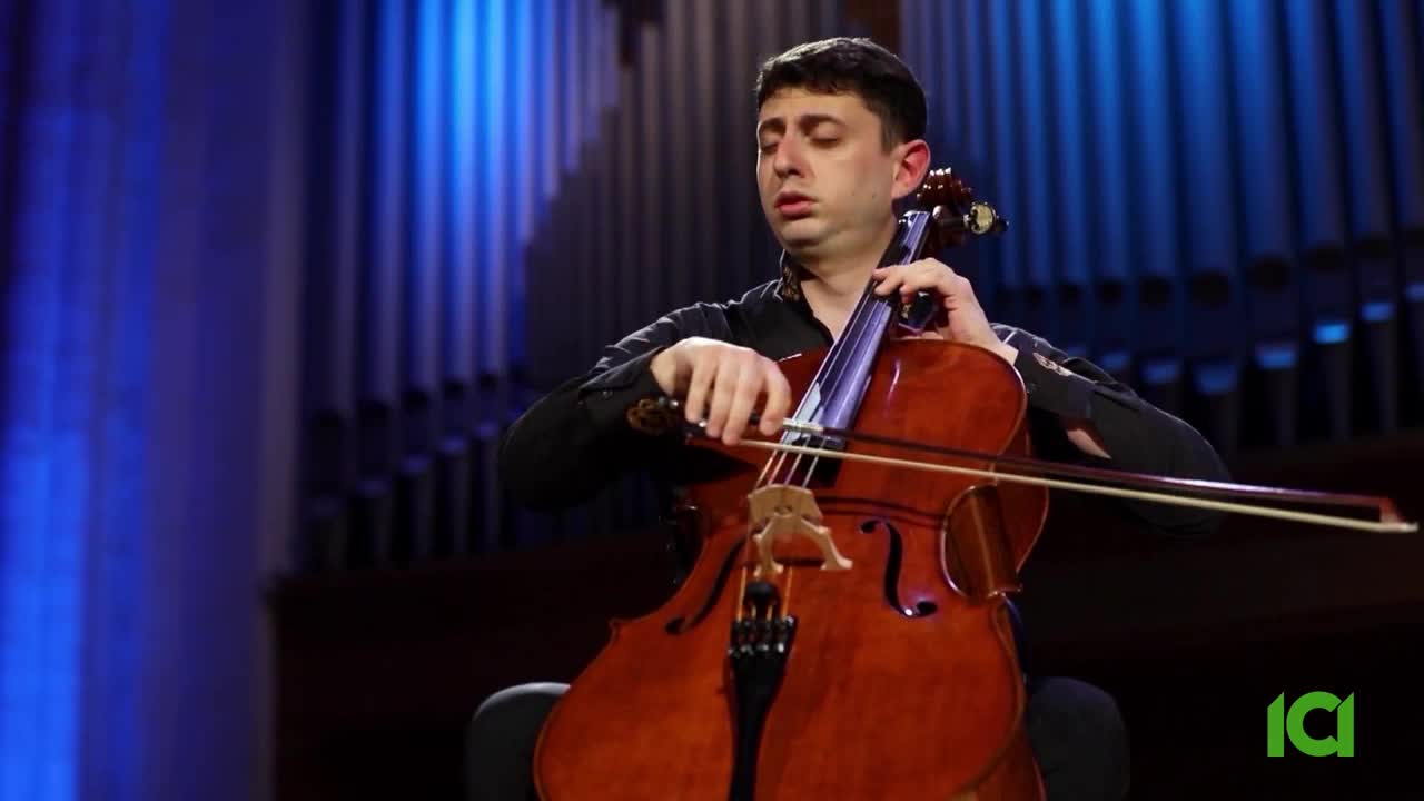 A man plays a cello, his bow drawing across the strings. The warm wood of the instrument gleams under stage lights. A man plays a cello, his bow drawing across the strings. The warm wood of the instrument gleams under stage lights.