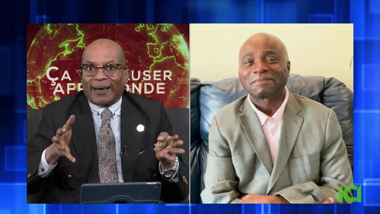 On the left, a man in a suit gestures animatedly during a broadcast for CFHD-DT. To his right, another man in a suit sits comfortably, looking directly ahead. On the left, a man in a suit gestures animatedly during a broadcast for CFHD-DT. To his right, another man in a suit sits comfortably, looking directly ahead.