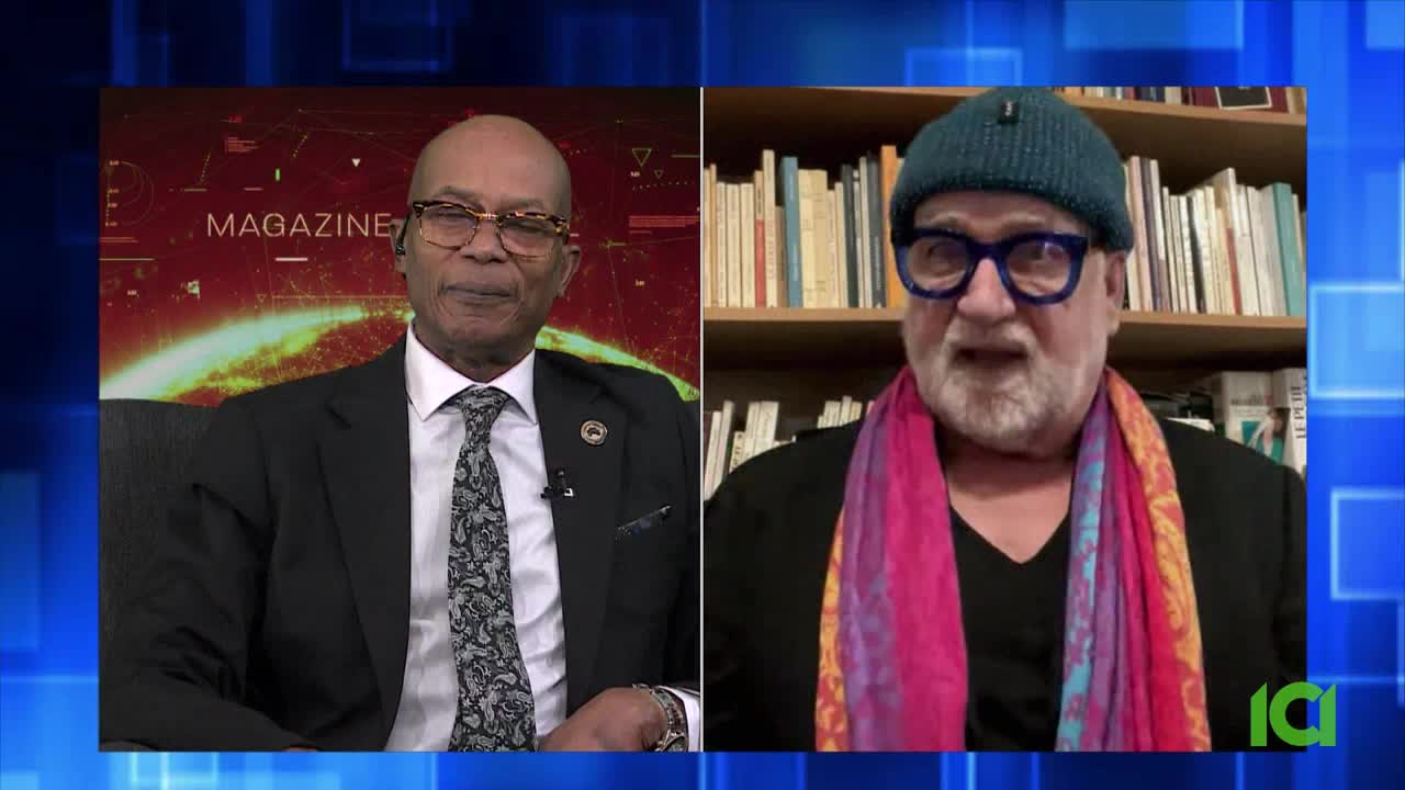 A man in a suit and tie speaks on a split screen, with the word "MAGAZINE" behind him. To his right, another man wearing a teal beanie and a colorful scarf talks from in front of a bookshelf.