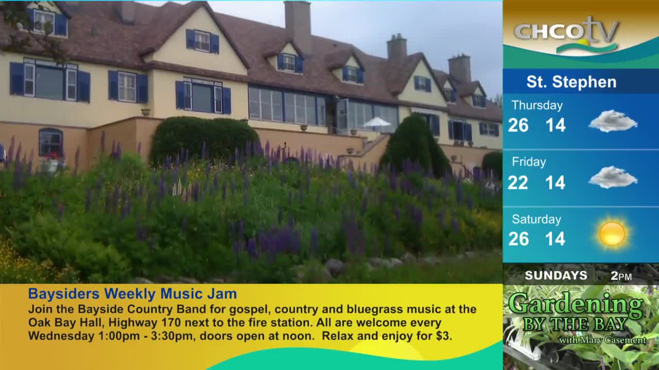 A large building with blue shutters sits behind a vibrant flower garden. The CHCO-TV weather report for St. Stephen, Canada, shows the upcoming forecast.
