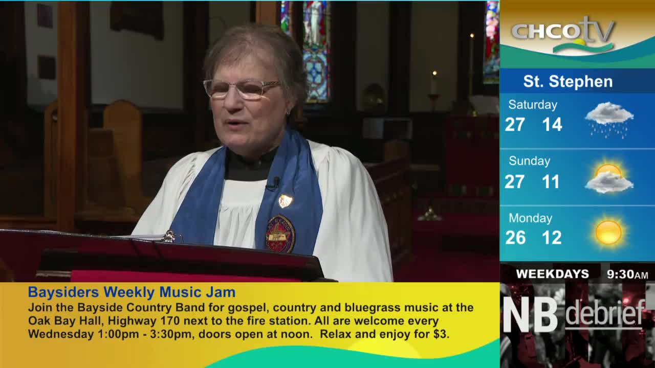 A woman in a clerical collar speaks from behind a wooden lectern. The weather forecast for St. Stephen, as seen on CHCO-TV, is displayed to the right.
