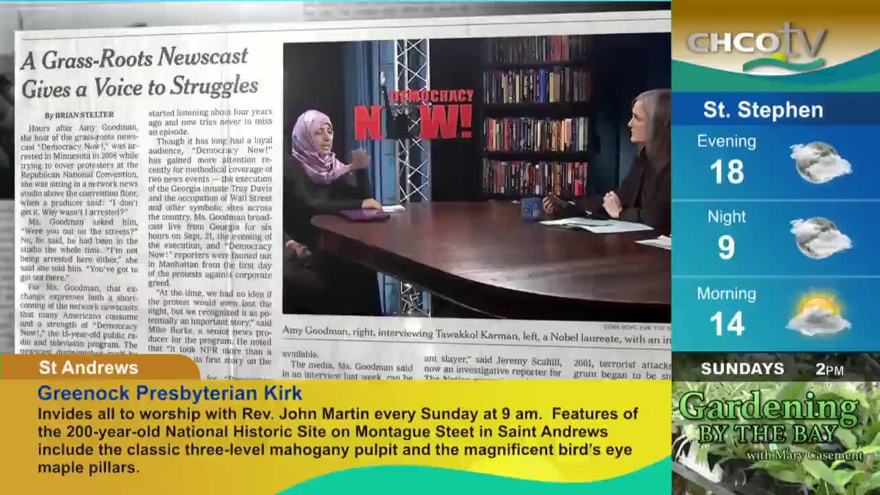 On a set for "Democracy Now!", Amy Goodman gestures as she interviews someone. The CHCO-TV weather report for St. Stephen sits to the right of the news clip.
