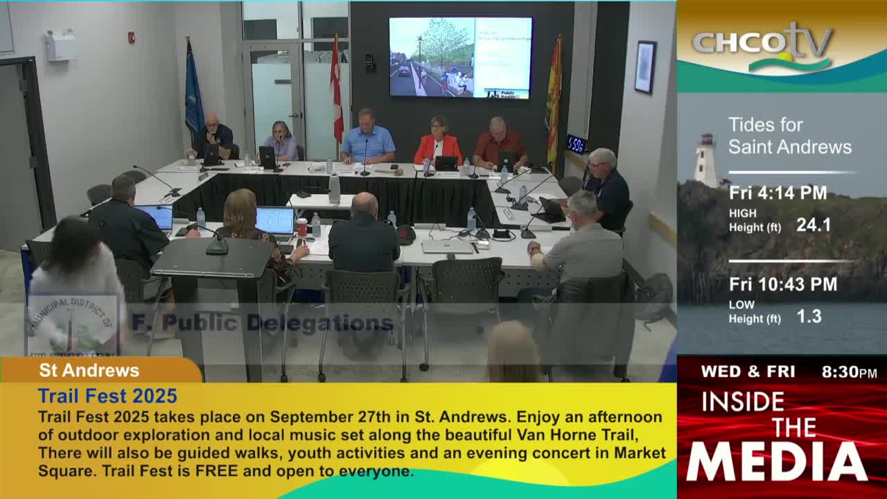 A group of people sit around a large table, some with laptops, in what looks like a government meeting. On the right, CHCO-TV's weather report for Saint Andrews displays tide information.
