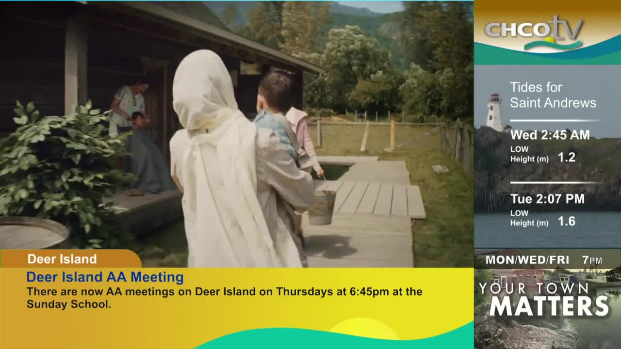 A person in a white head covering carries a child and walks towards a wooden walkway. Behind them, someone is getting a haircut on a porch, as CHCO-TV displays information about Deer Island.
