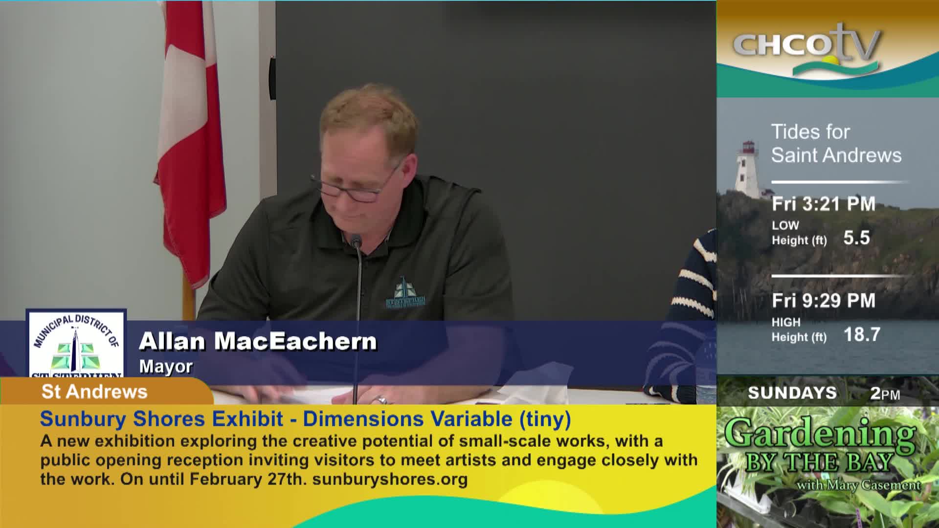 The mayor of St. Andrews, Allan MacEachern, is speaking at a table. A CHCO-TV graphic displays tide times for Saint Andrews and a gardening show.