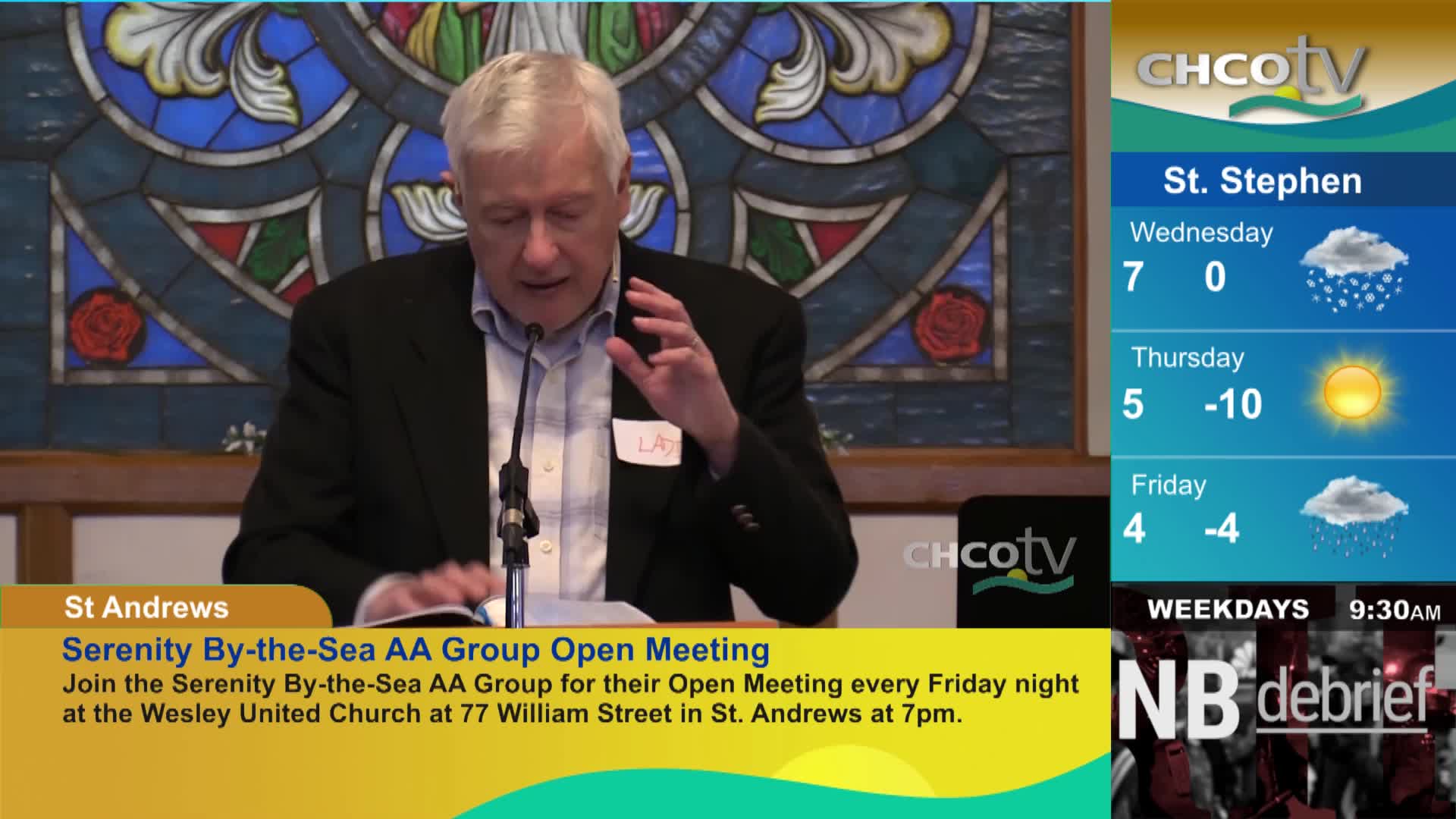 A man in a dark jacket speaks into a microphone, gesturing with his right hand. A CHCO-TV graphic displays weather for St. Stephen, showing rain on Wednesday and Friday, and sun with cold temperatures on Thursday.