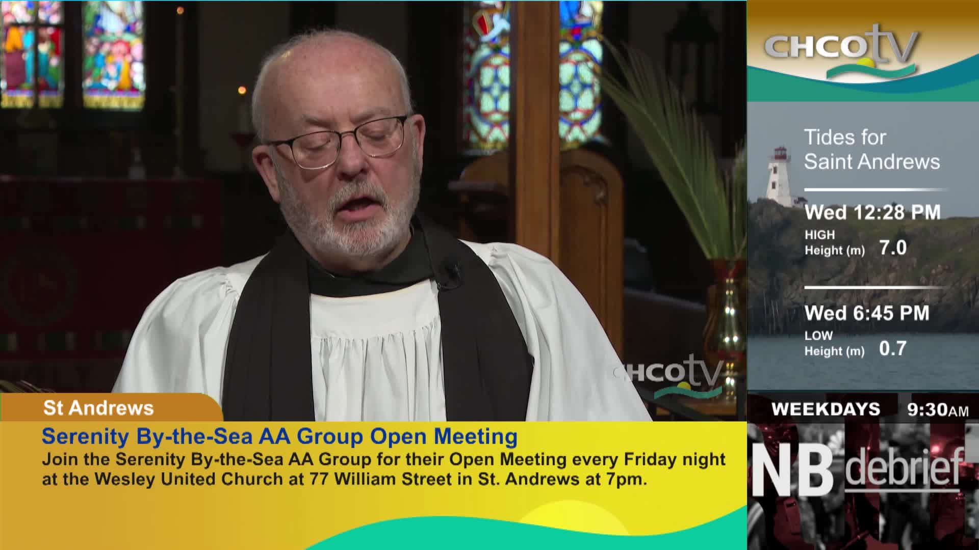 A man in clerical attire speaks into a microphone. To his right, a CHCO-TV graphic displays tide information for Saint Andrews. A man in clerical attire speaks into a microphone. To his right, a CHCO-TV graphic displays tide information for Saint Andrews.