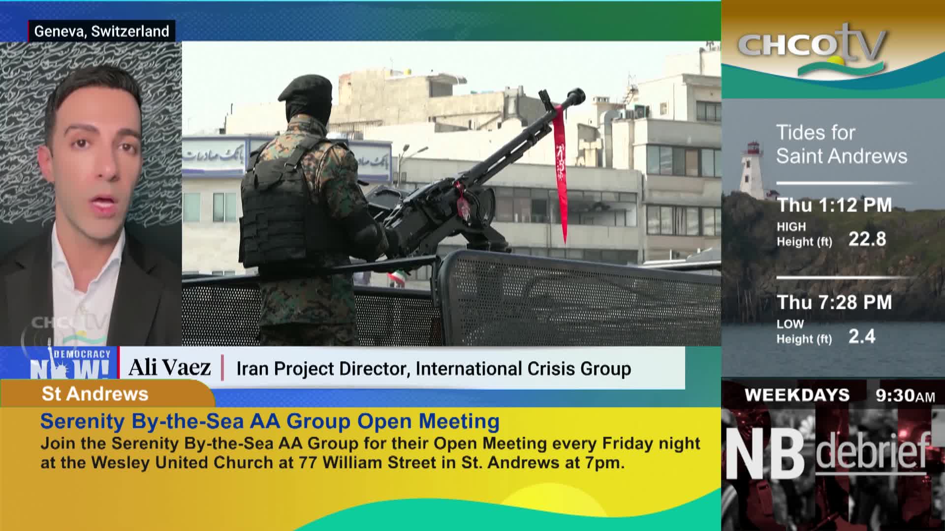 A soldier stands guard with a heavy machine gun mounted on a vehicle. A red ribbon hangs from the barrel. A soldier stands guard with a heavy machine gun mounted on a vehicle. A red ribbon hangs from the barrel.