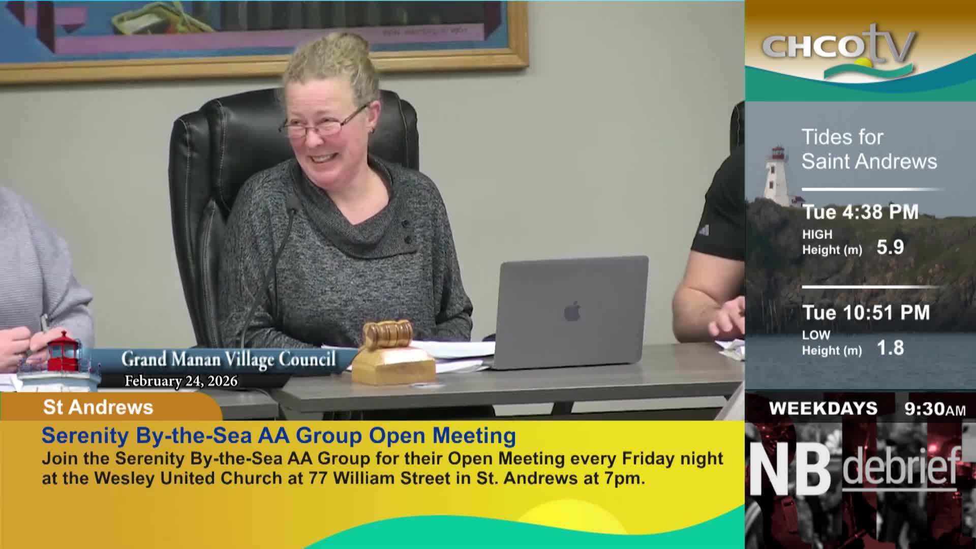 A woman at a table smiles, leaning back in her chair. A CHCO-TV graphic displays tide information for Saint Andrews.