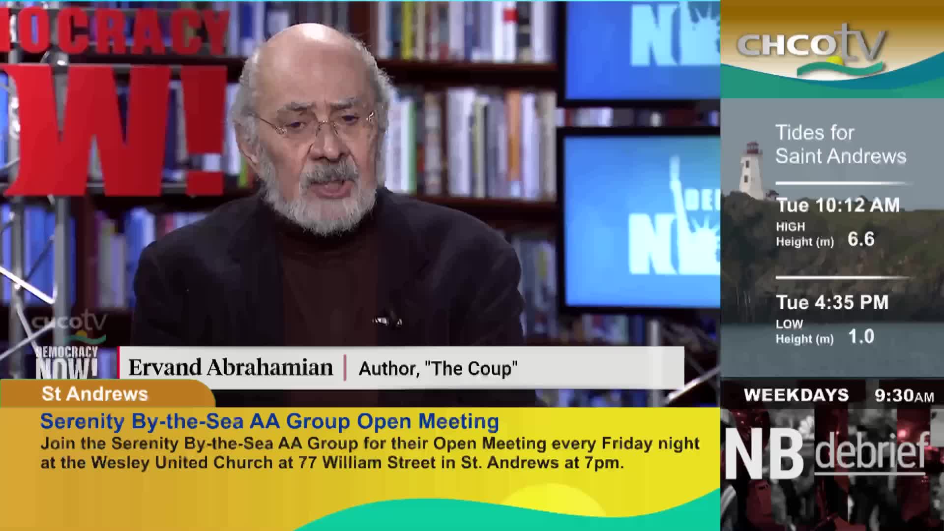 An older gentleman with a beard is speaking on a television program. A graphic displays tide times for Saint Andrews, New Brunswick, and another shows a segment titled "NB debrief."
