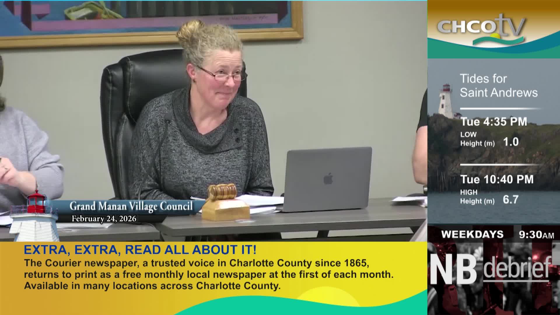 A woman in glasses leans forward, listening intently. On the right, a CHCO-TV graphic displays tide information for Saint Andrews.
