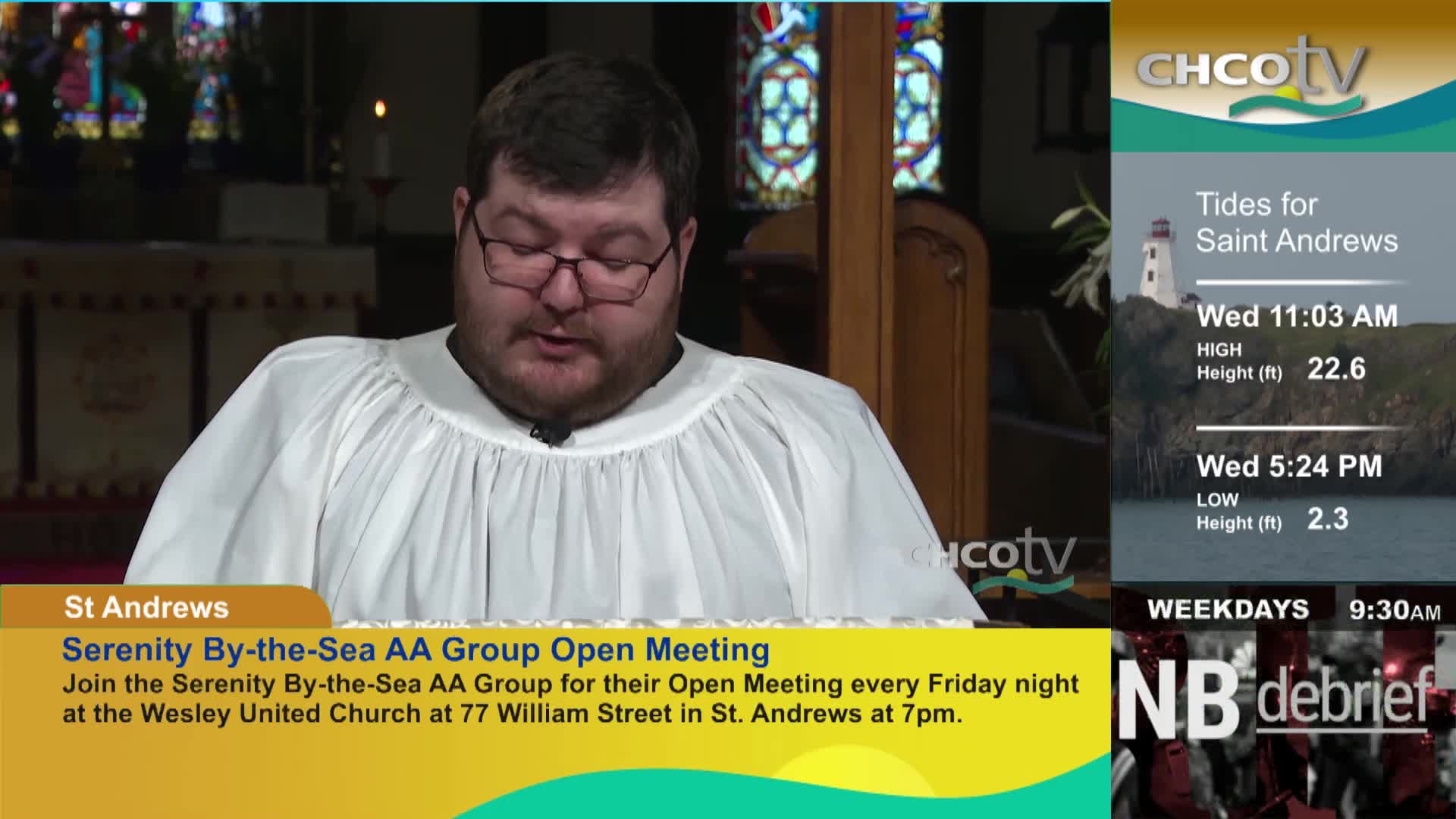 A man in a white robe reads from a book in front of stained glass windows. To the right, CHCO-TV displays tide information for Saint Andrews and a program called "NB debrief."