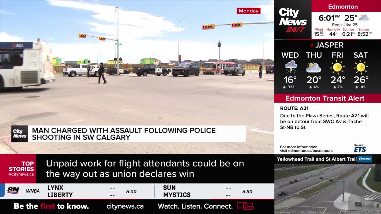 A man walks across a wide intersection, while several police vehicles are parked nearby. The CityNews Calgary banner at the bottom of the screen reports on a shooting in SW Calgary.
