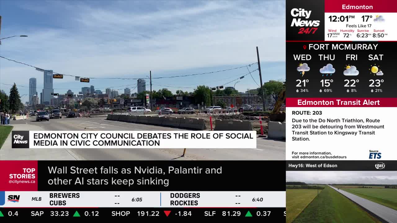 Traffic flows along a wide road in Edmonton, with construction barriers lining the center. The CityNews 24/7 graphic reports on the city council's debate about social media.
