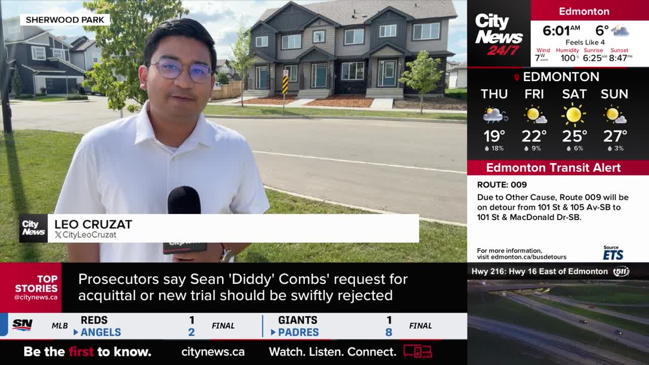 Leo Cruzat from CityNews is reporting live from Sherwood Park, holding a microphone in front of a row of townhouses. The Edmonton weather forecast is displayed on the screen, along with a transit alert.
