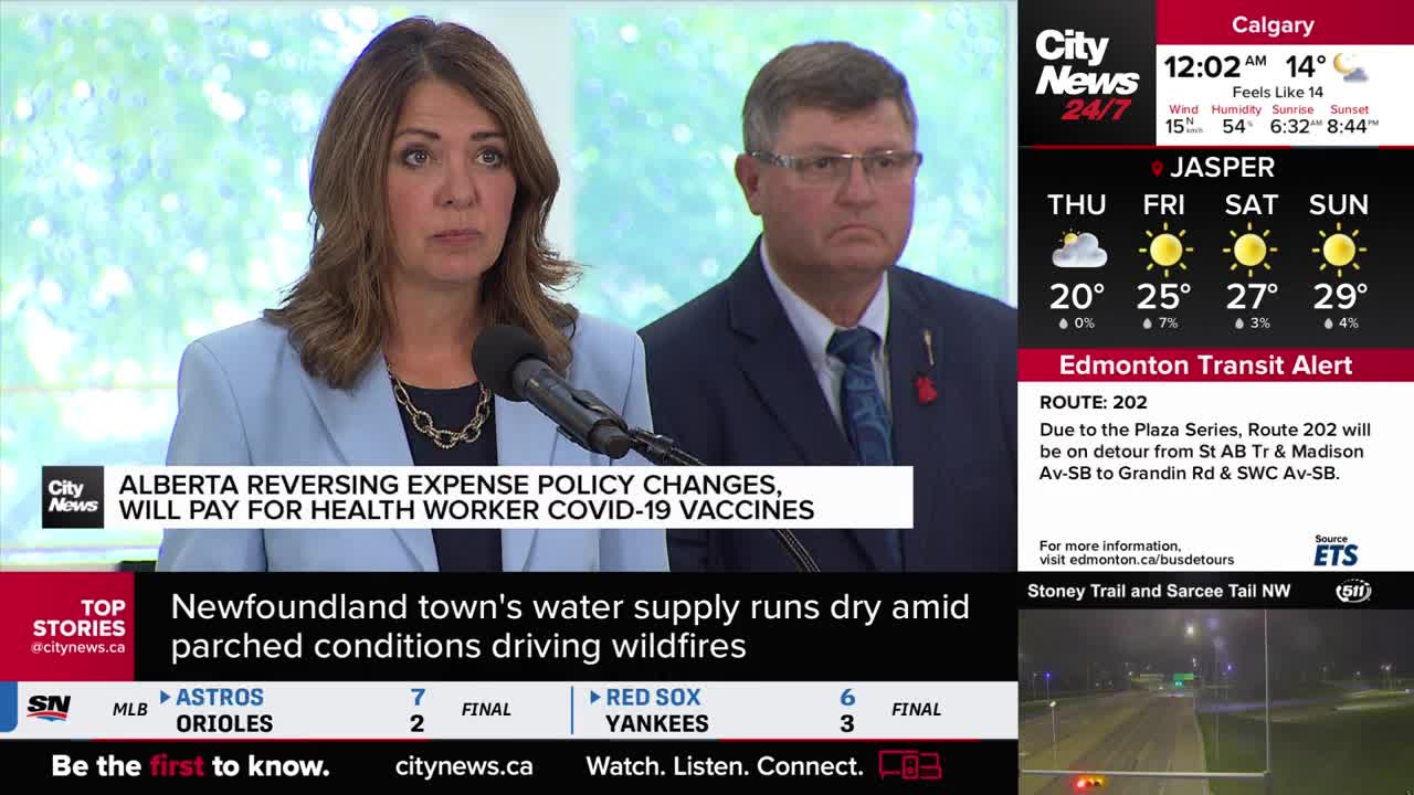 A woman in a light blue blazer speaks into a microphone, flanked by a man in a dark suit. The CityNews Calgary logo is visible, along with a headline about Alberta's policy changes.

