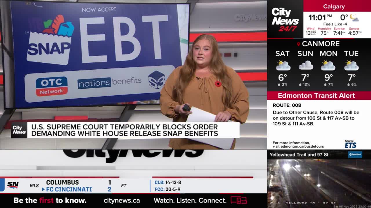 A CityNews Calgary anchor stands in front of a screen, holding a script and speaking. Behind her, a graphic displays information about EBT and SNAP benefits, with a headline about a U.S. Supreme Court decision.
A CityNews Calgary anchor stands in front of a screen, holding a script and speaking. Behind her, a graphic displays information about EBT and SNAP benefits, with a headline about a U.S. Supreme Court decision.