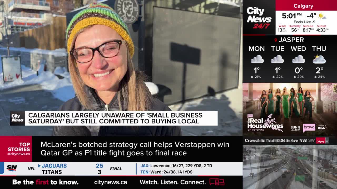 A woman in a colorful hat and glasses smiles, speaking to a CityNews Calgary reporter. The backdrop is a sunny, snowy street scene, with a sign casting a long shadow.
