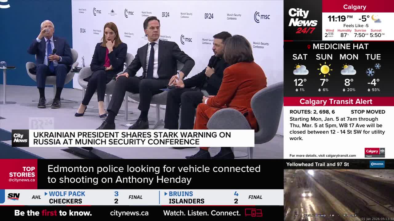 A panel of speakers sits on stage, with the Ukrainian president in the center. The CityNews Calgary screen displays weather updates and a transit alert for the city.
