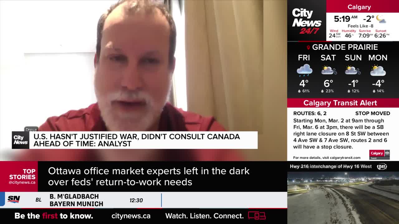 A man with a beard speaks from a screen, his words about the U.S. not consulting Canada on war appearing below him. To the right, weather forecasts for Grande Prairie and a Calgary Transit alert scroll by.