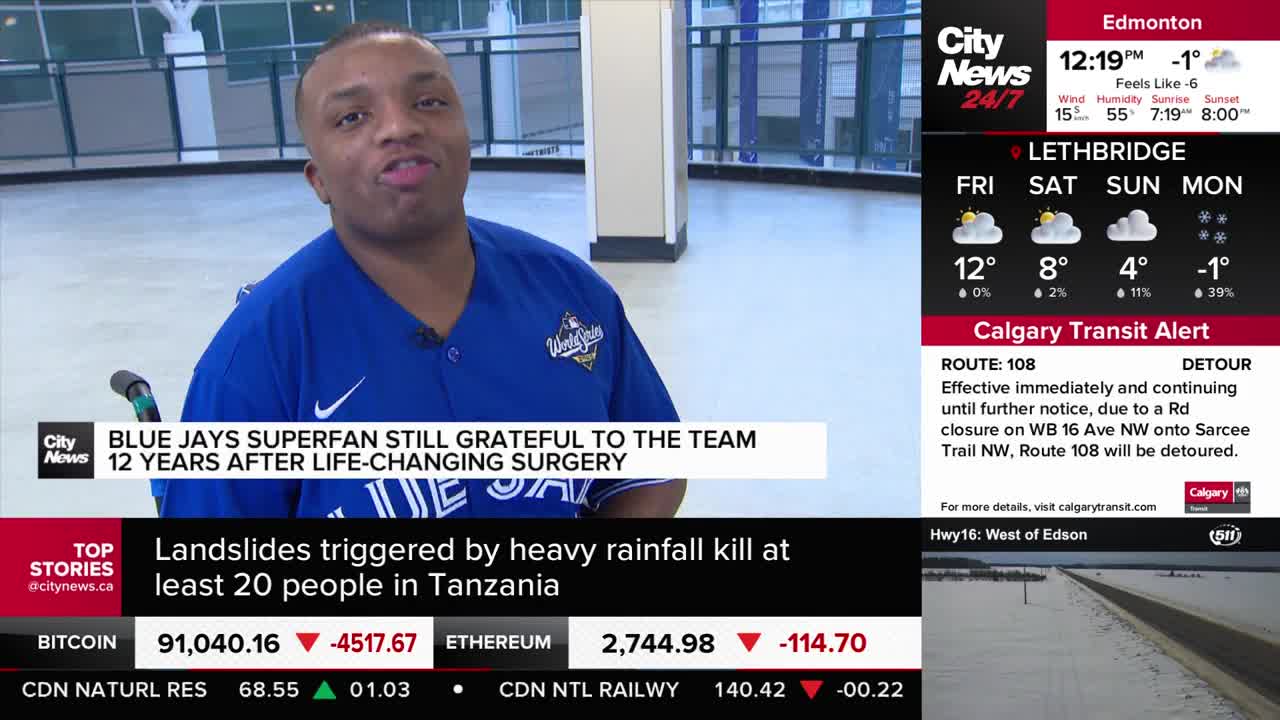 A man in a blue Blue Jays jersey speaks directly to the camera. A news ticker scrolls below, reporting on a Calgary Transit Alert for Route 108.