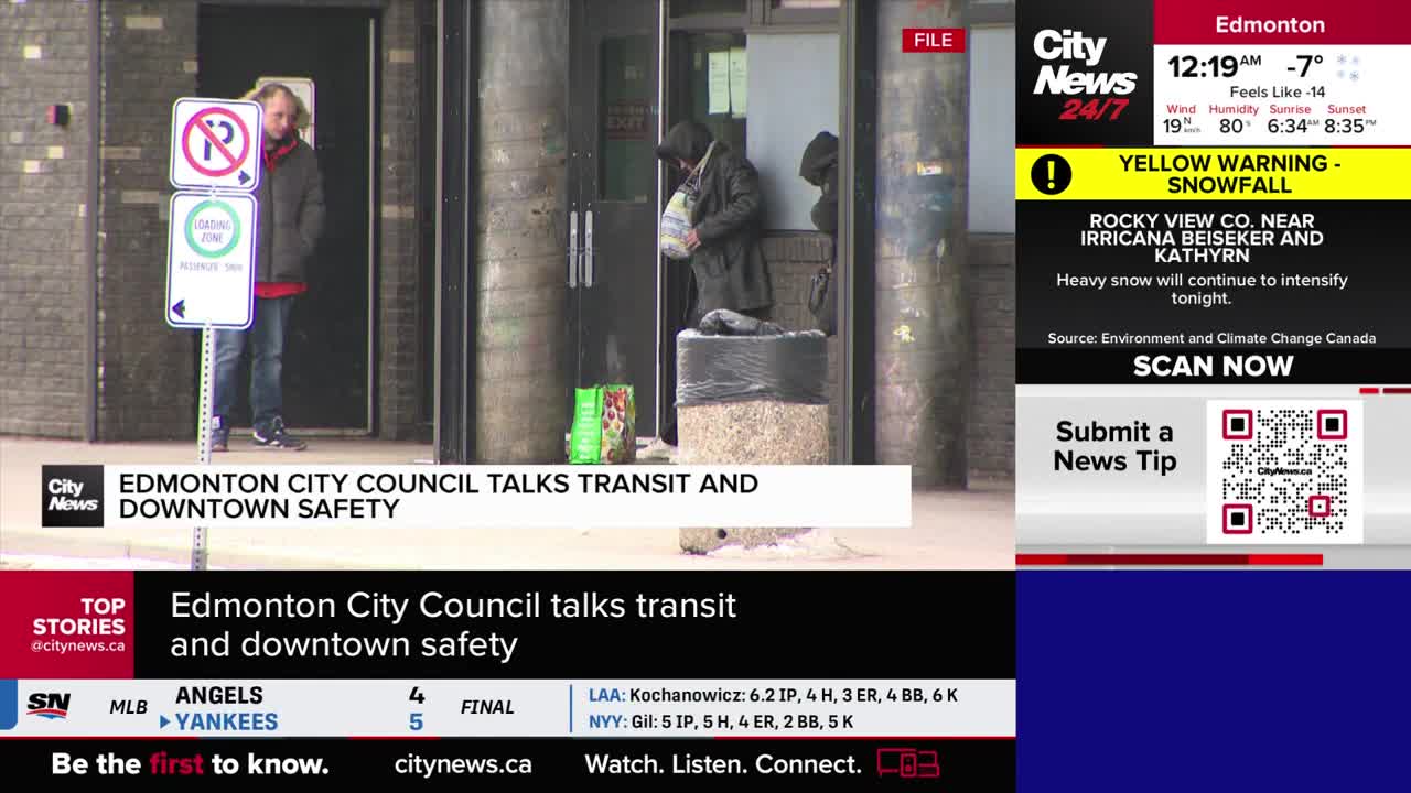 A man stands by a "No Parking" sign, looking towards an entrance. Two people are gathered near a doorway, one holding a bag.