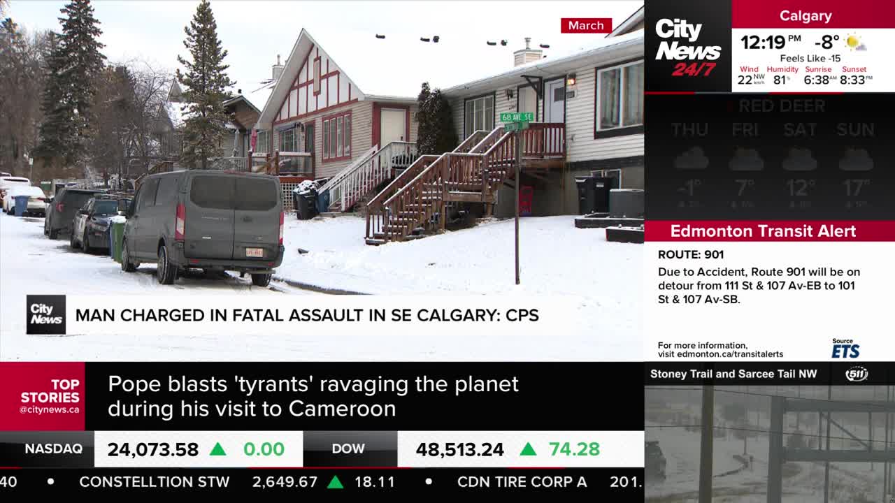 A dark grey van is parked on a snow-covered street in front of a row of houses. A CityNews Calgary chyron states a man has been charged in a fatal assault in SE Calgary.