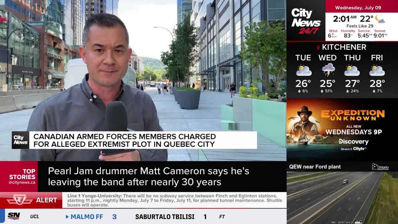 A CityNews Toronto reporter stands on a city street, microphone in hand, speaking directly to the camera. Behind him, people stroll on the sidewalk and a news ticker scrolls across the bottom of the screen.
