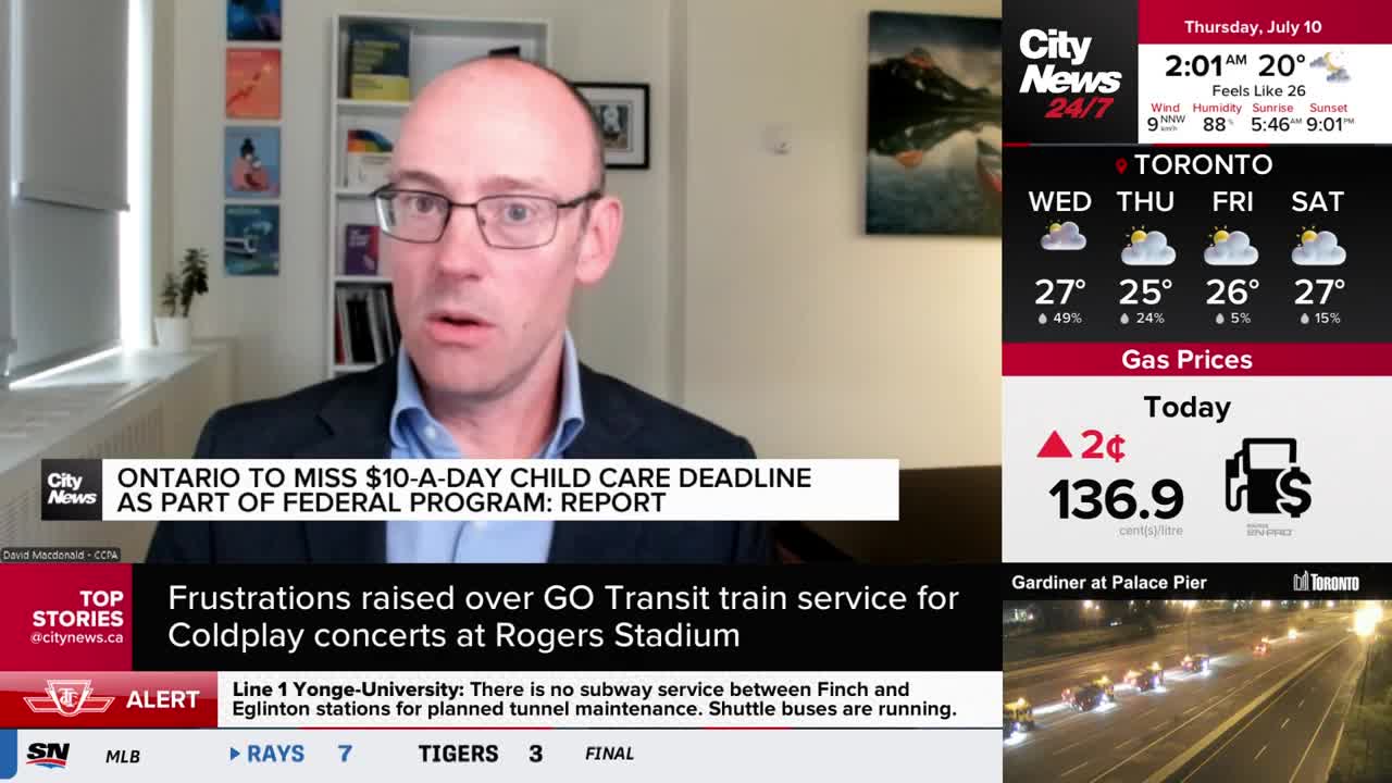 A man in glasses is speaking directly to the camera, his face lit by studio lights. The CityNews Toronto logo is visible, and a headline about Ontario's child care program scrolls below.
