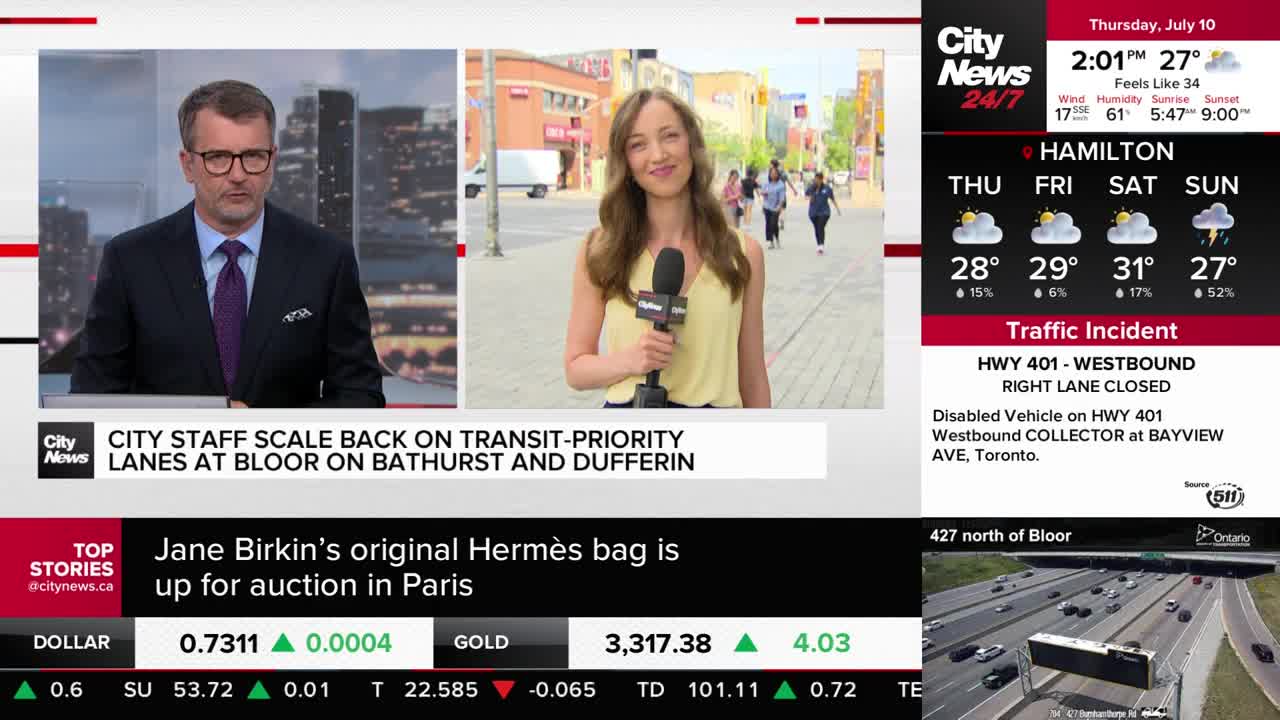 A CityNews Toronto reporter stands on a sunny street holding a microphone, with people walking in the background. Across the screen, a news anchor in a suit is reporting from the studio.
