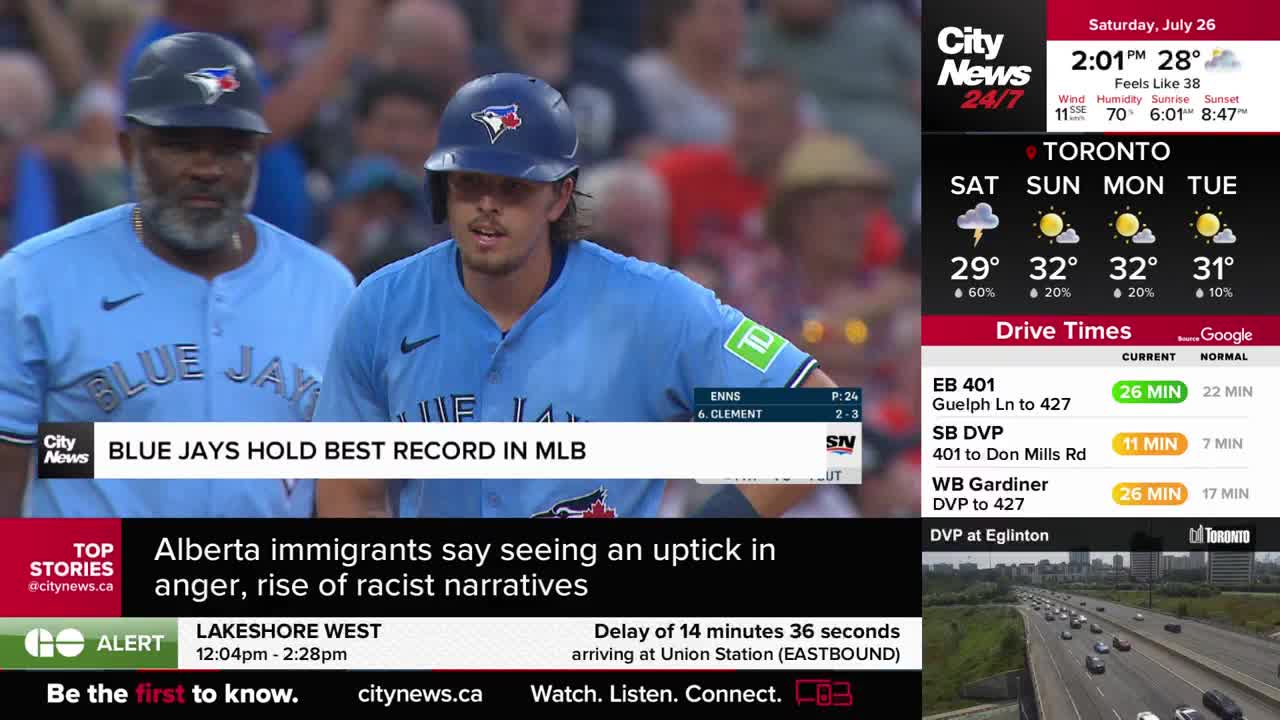A Toronto Blue Jays player in a blue uniform is walking toward the camera. The CityNews Toronto graphic declares the team holds the best record in MLB.
